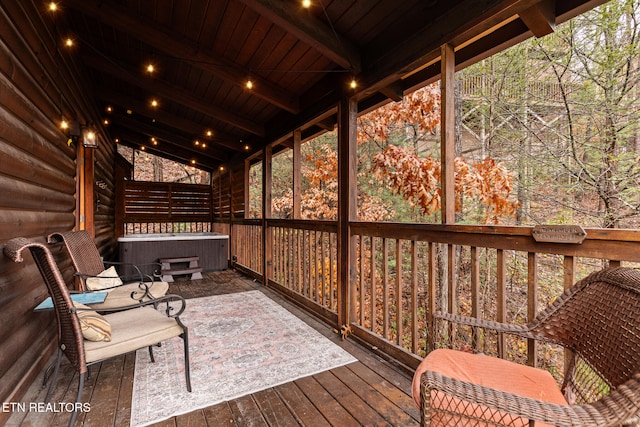 wooden deck with a hot tub