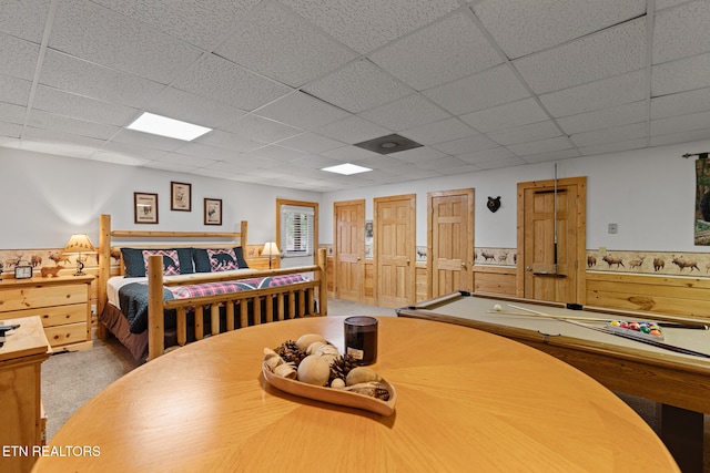 bedroom featuring carpet flooring, a drop ceiling, and pool table