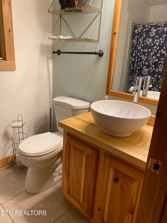 bathroom featuring tile patterned flooring, vanity, and toilet