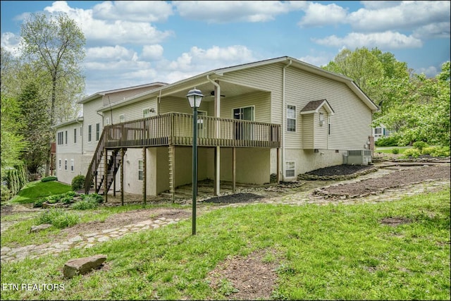 back of house featuring a deck and central AC