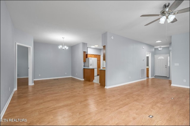 unfurnished living room featuring light hardwood / wood-style flooring and ceiling fan with notable chandelier