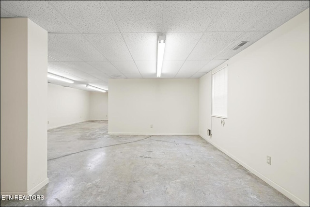 basement with a paneled ceiling