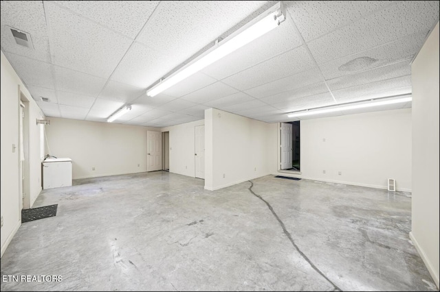 basement featuring a paneled ceiling