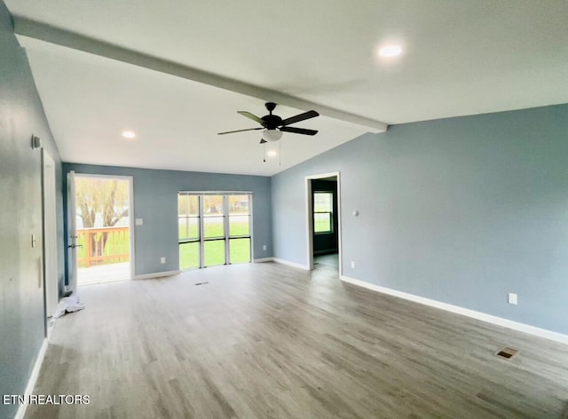 empty room featuring wood-type flooring, vaulted ceiling with beams, and ceiling fan