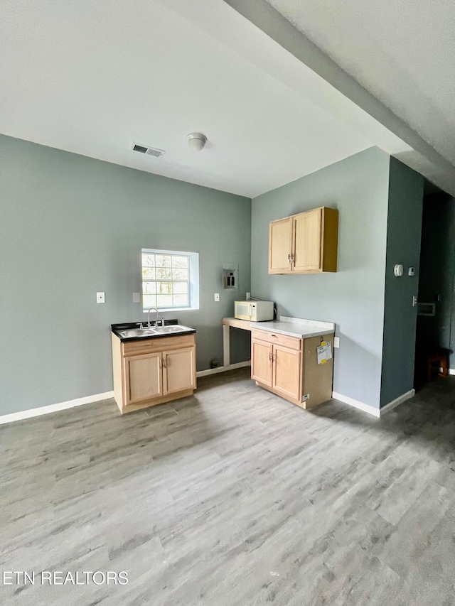 kitchen featuring light brown cabinets, light hardwood / wood-style flooring, and sink