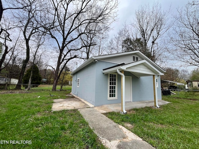 view of property exterior with a yard