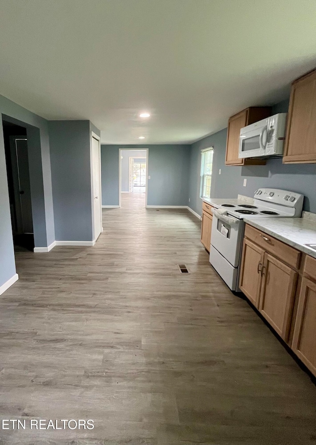 kitchen with light wood-type flooring and white appliances