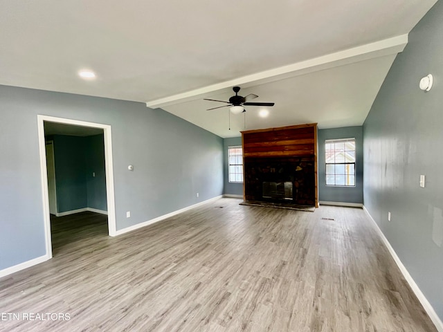 unfurnished living room featuring vaulted ceiling with beams, light hardwood / wood-style floors, and ceiling fan