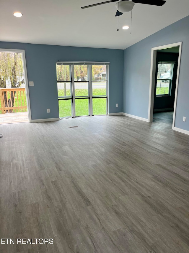 unfurnished living room with ceiling fan and hardwood / wood-style floors