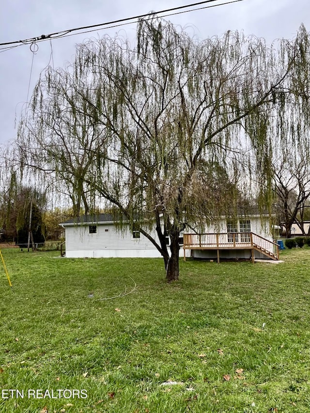 view of yard with a wooden deck