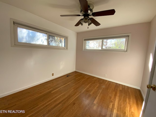 empty room featuring hardwood / wood-style floors and ceiling fan