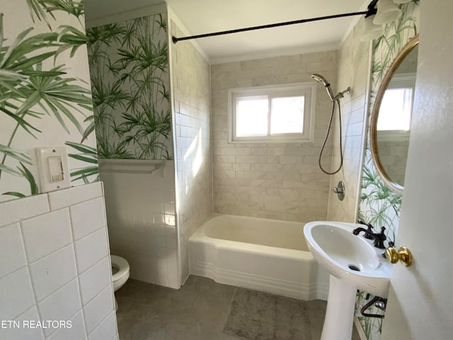 bathroom featuring tiled shower / bath combo, toilet, and crown molding