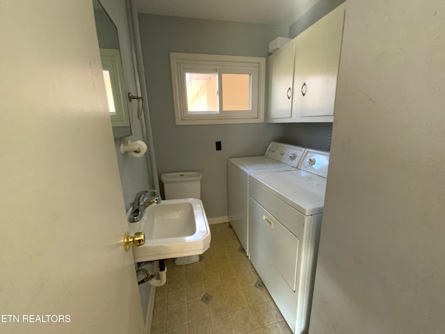 laundry area featuring washing machine and clothes dryer and sink