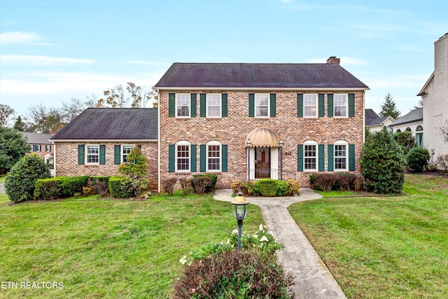colonial-style house with a front yard