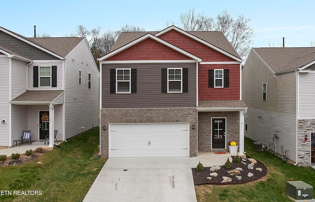 view of front facade with central AC unit, a front yard, and a garage