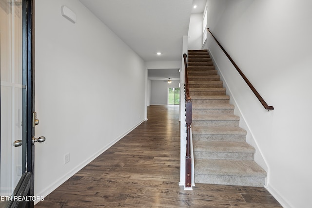 stairway featuring hardwood / wood-style floors and ceiling fan