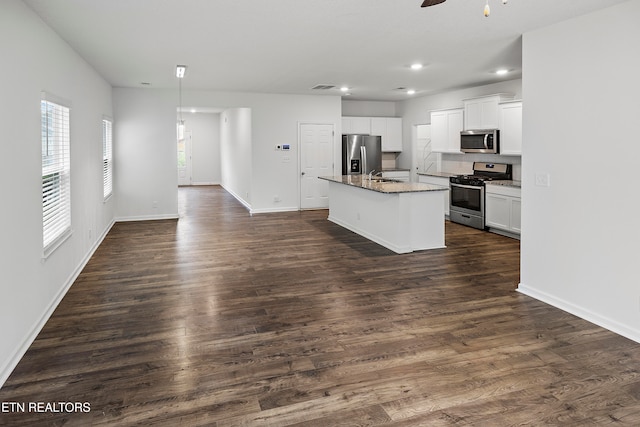 kitchen featuring sink, dark hardwood / wood-style floors, a center island with sink, white cabinets, and appliances with stainless steel finishes