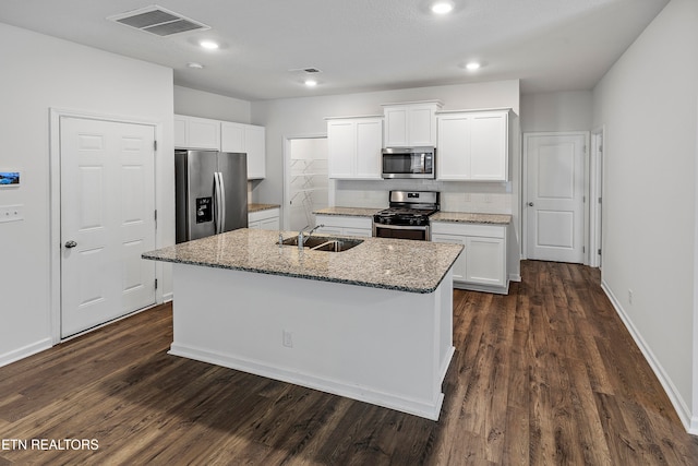 kitchen featuring appliances with stainless steel finishes, a center island with sink, white cabinetry, and sink