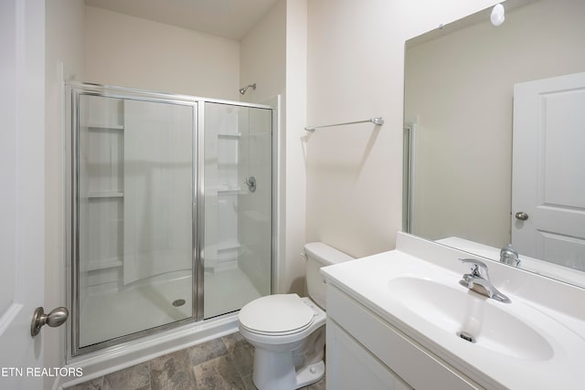 bathroom featuring hardwood / wood-style flooring, vanity, toilet, and walk in shower