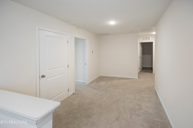 empty room featuring light colored carpet