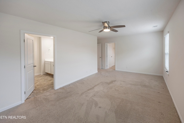 carpeted spare room featuring ceiling fan