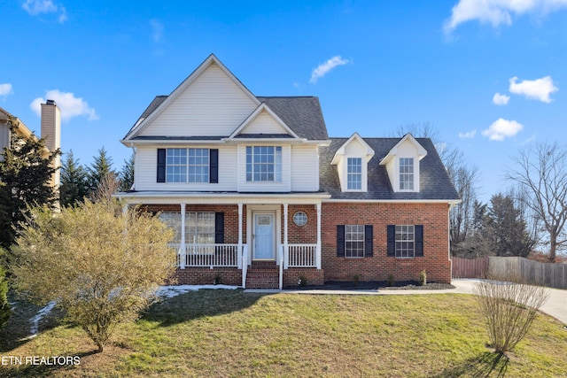 view of front of property featuring covered porch and a front lawn