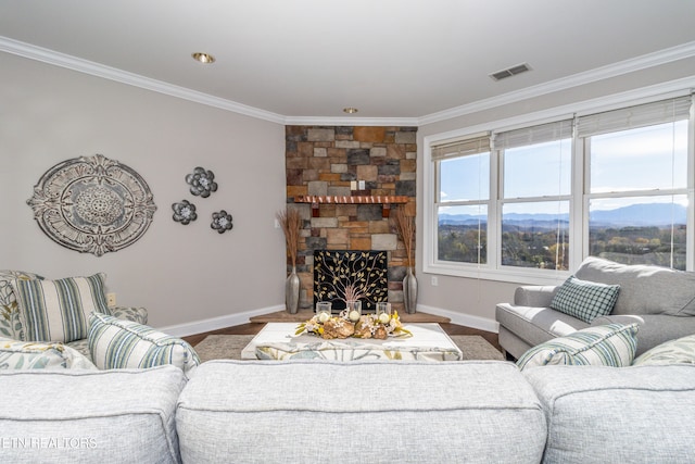 living room featuring a fireplace, a mountain view, hardwood / wood-style floors, and ornamental molding