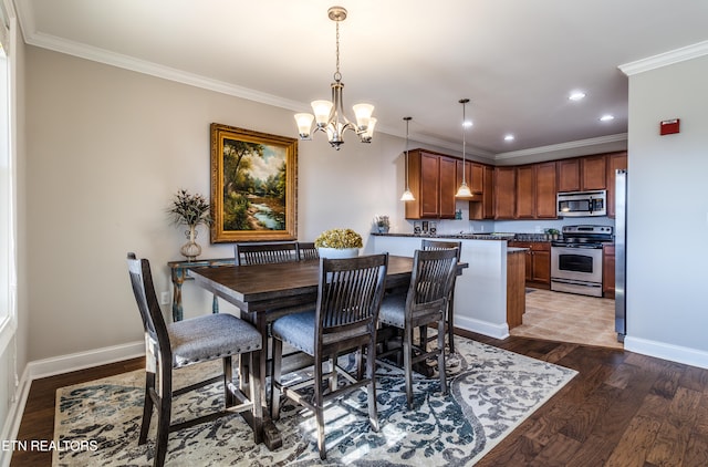 dining area featuring a notable chandelier, dark hardwood / wood-style flooring, and crown molding