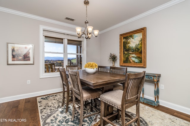 dining area featuring a notable chandelier, dark hardwood / wood-style flooring, and crown molding