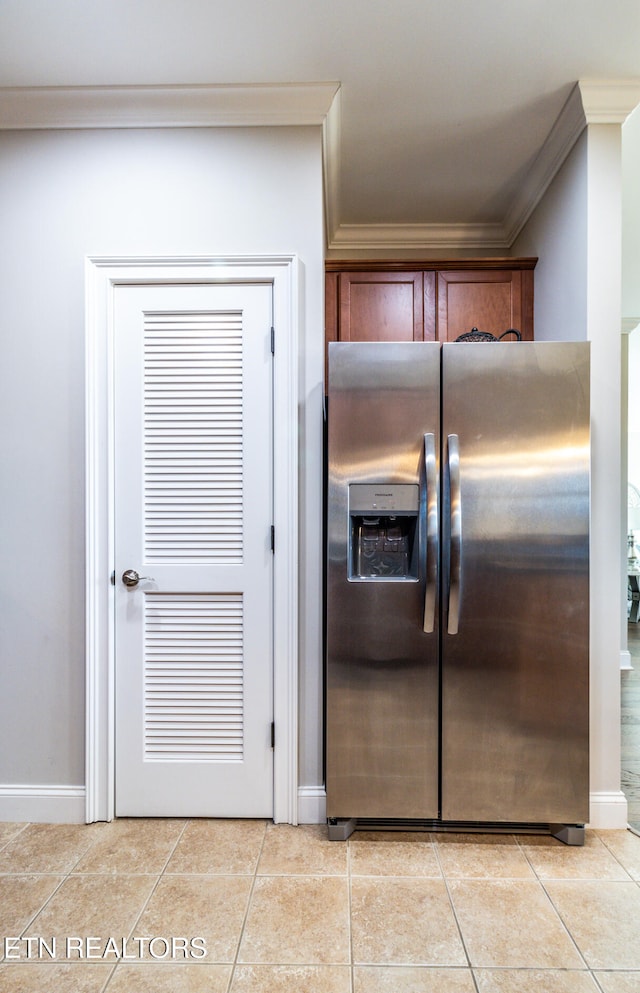 kitchen with stainless steel fridge with ice dispenser, crown molding, and light tile patterned flooring