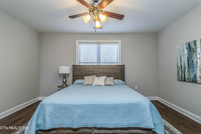 bedroom with ceiling fan and dark wood-type flooring