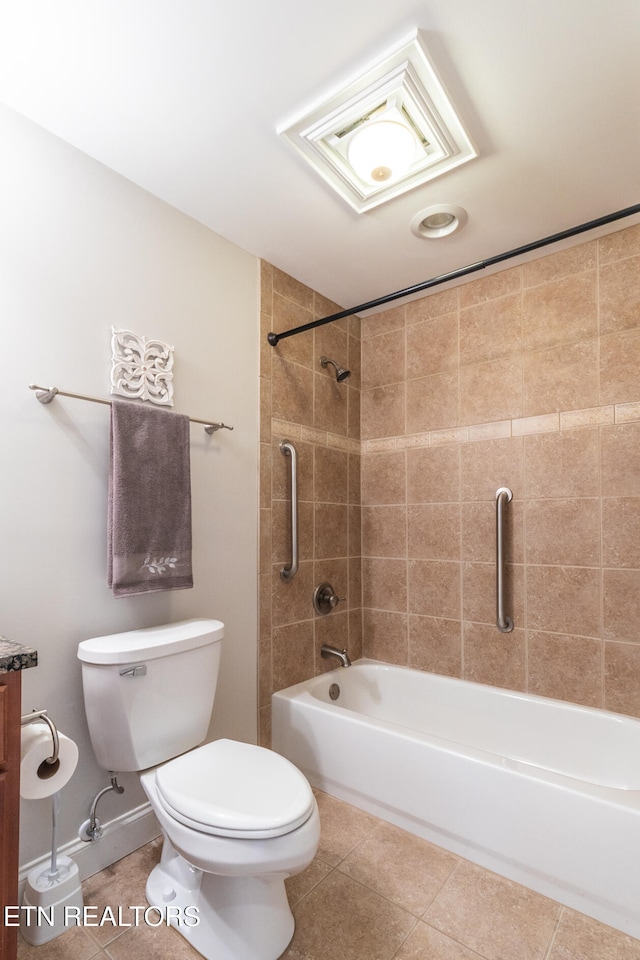 bathroom with tile patterned flooring, tiled shower / bath combo, and toilet