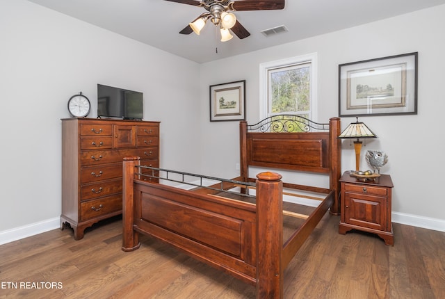 bedroom with ceiling fan and dark wood-type flooring