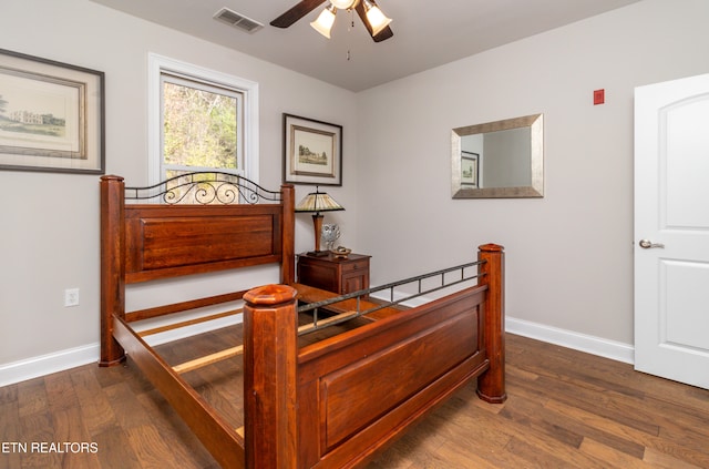 bedroom with dark hardwood / wood-style floors and ceiling fan