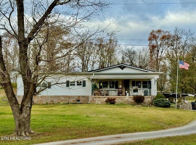 view of front of home featuring covered porch and a front yard