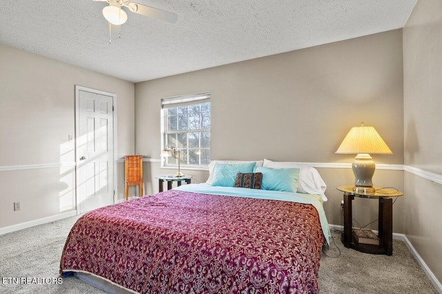 carpeted bedroom featuring a textured ceiling and ceiling fan