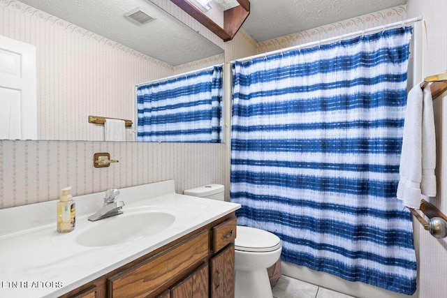 bathroom featuring vanity, a textured ceiling, tile patterned flooring, toilet, and curtained shower