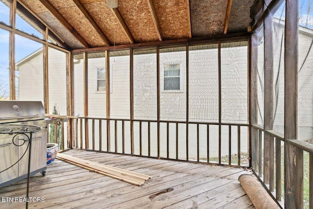 unfurnished sunroom with lofted ceiling