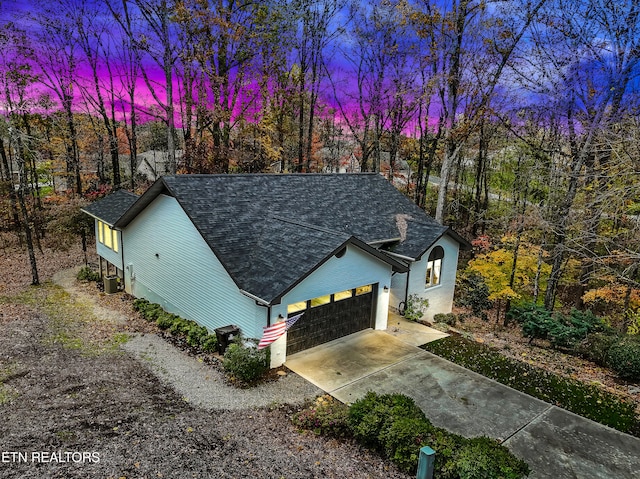 view of front of house with a garage and central air condition unit