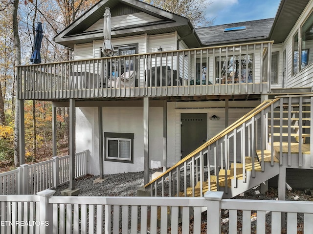 rear view of house featuring a deck