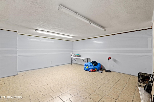 basement featuring a textured ceiling