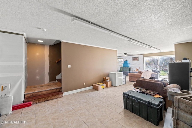 tiled living room featuring ceiling fan and a textured ceiling