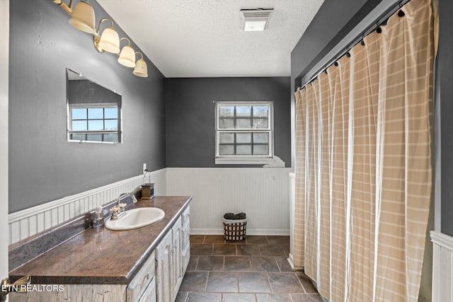 bathroom with vanity and a textured ceiling