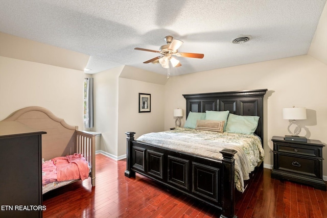 bedroom featuring lofted ceiling, ceiling fan, dark wood-type flooring, and a textured ceiling