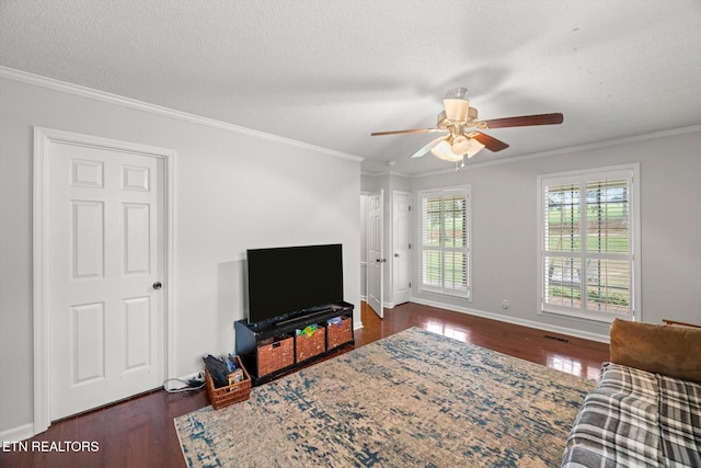 living room featuring dark hardwood / wood-style floors, ceiling fan, crown molding, and a textured ceiling