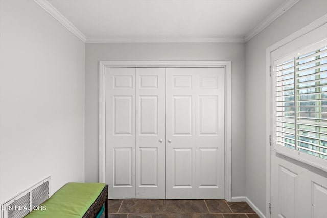 unfurnished bedroom featuring multiple windows, a closet, and ornamental molding