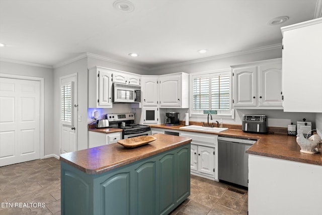 kitchen featuring plenty of natural light, white cabinets, and appliances with stainless steel finishes