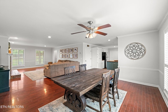 dining space featuring ceiling fan, crown molding, and dark wood-type flooring