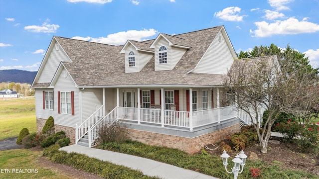 view of front of house with a mountain view and a porch