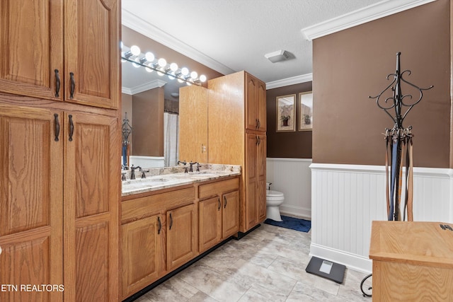 bathroom featuring a textured ceiling, vanity, toilet, and crown molding